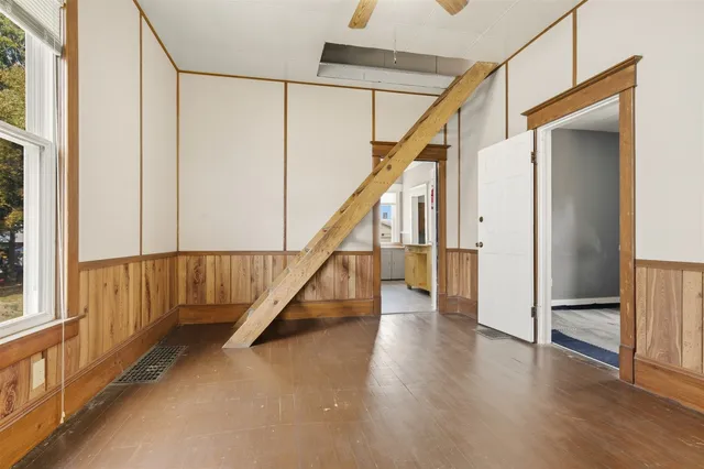 a view of entryway with wooden floor and stairs