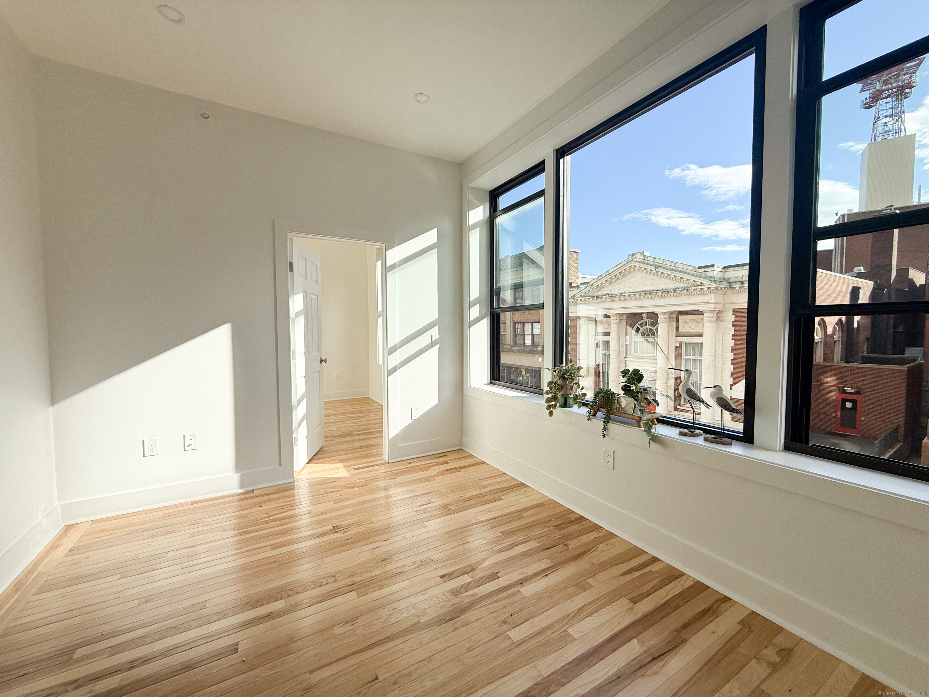 253 State Street, Unit 2L New London, CT 06320 - Photo 3 of 8 a view of a livingroom with wooden floor and furniture
