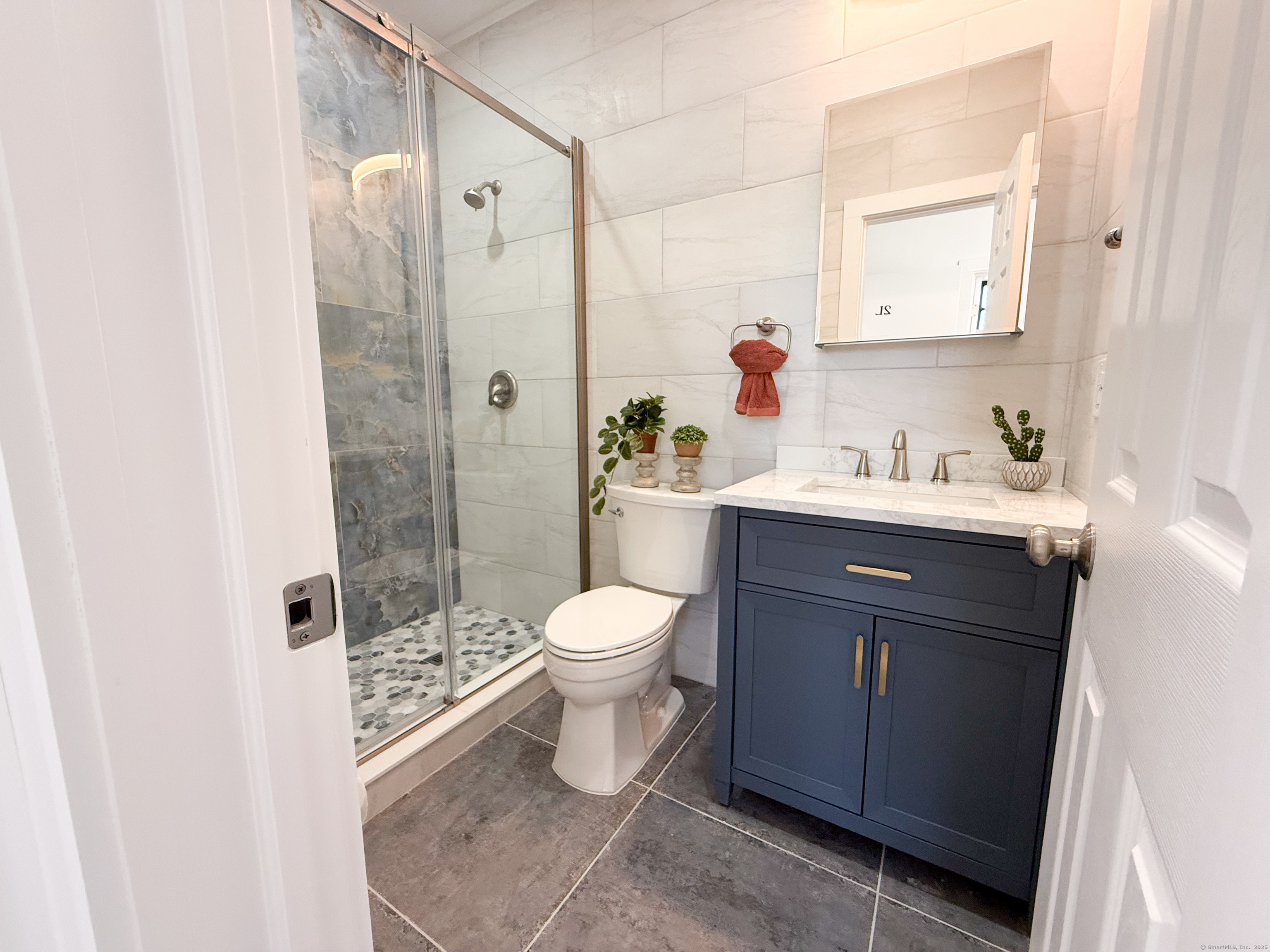 253 State Street, Unit 2L New London, CT 06320 - Photo 4 of 8 a bathroom with a sink toilet a mirror and shower