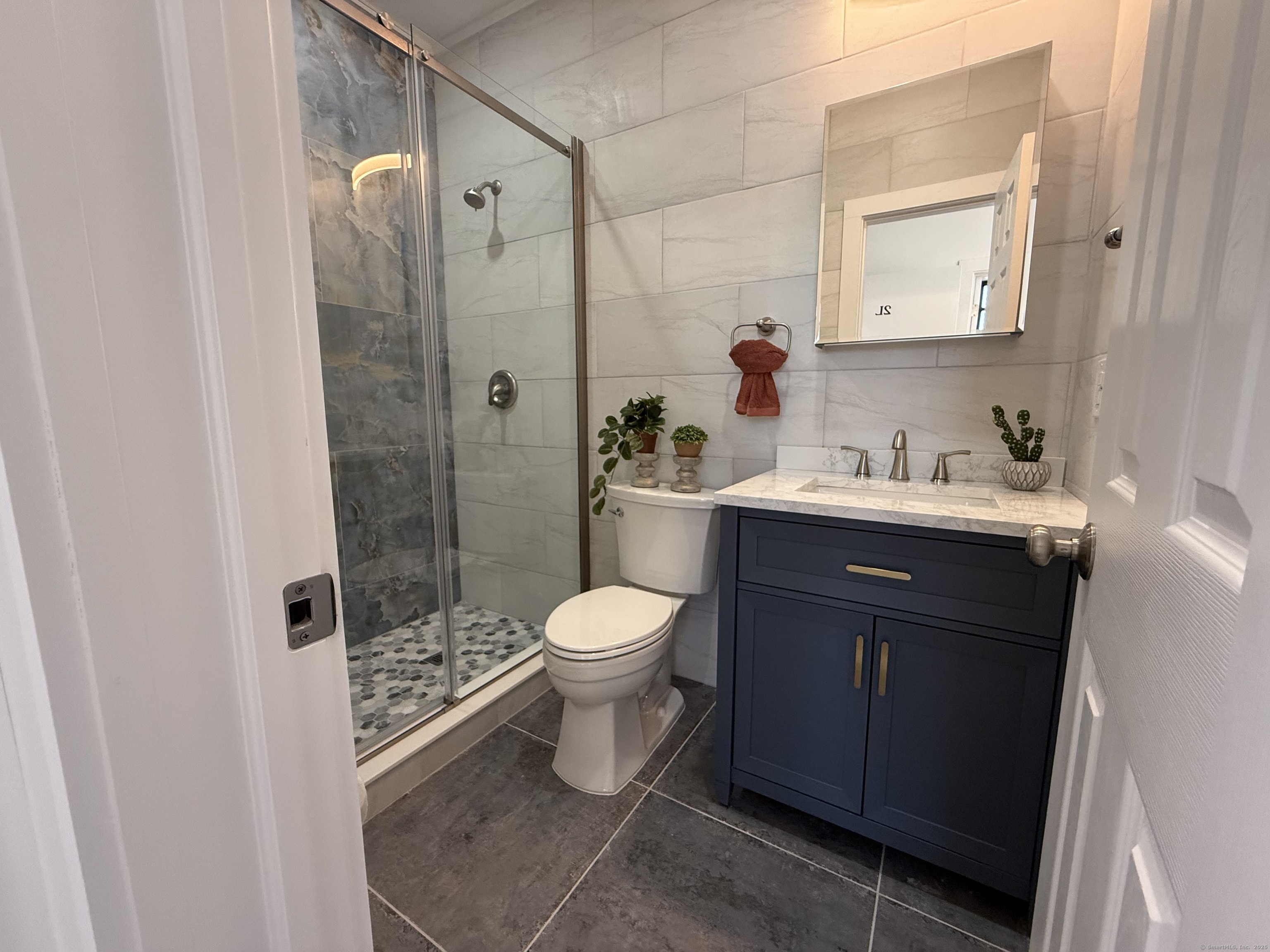 253 State Street, Unit 2L New London, CT 06320 - Photo 5 of 8 a bathroom with a sink toilet a mirror and shower
