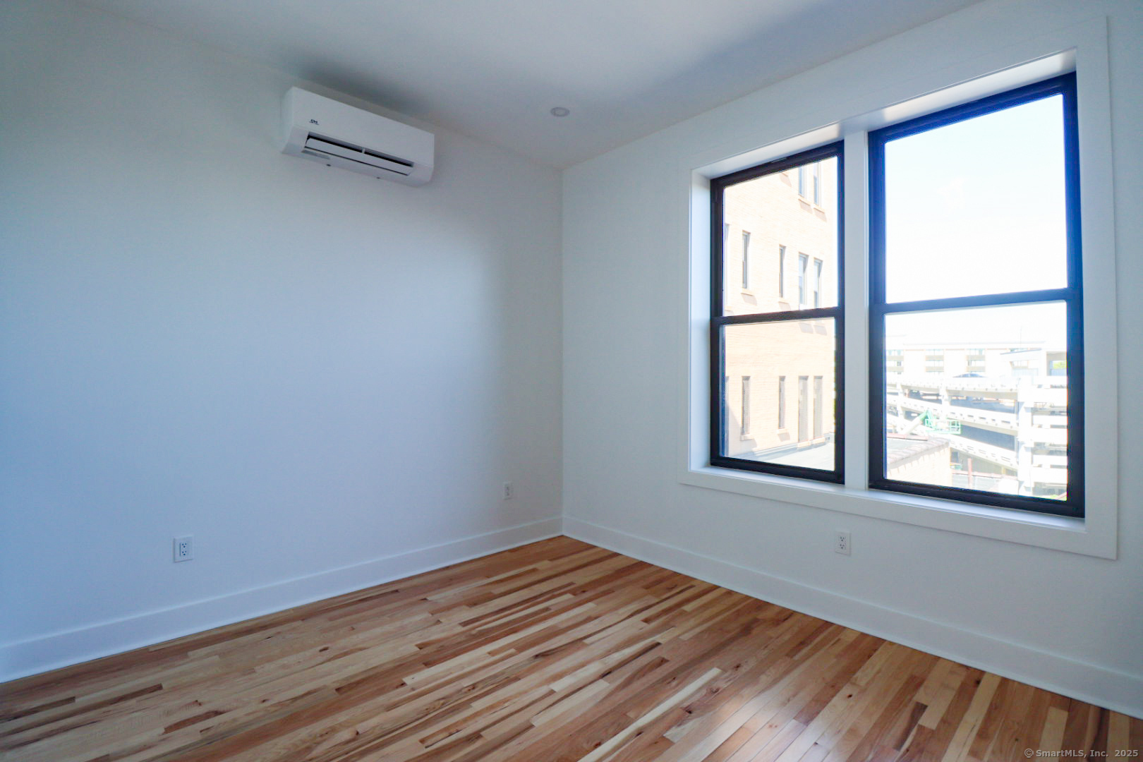 253 State Street, Unit 2L New London, CT 06320 - Photo 8 of 8 a view of an empty room with wooden floor and a window