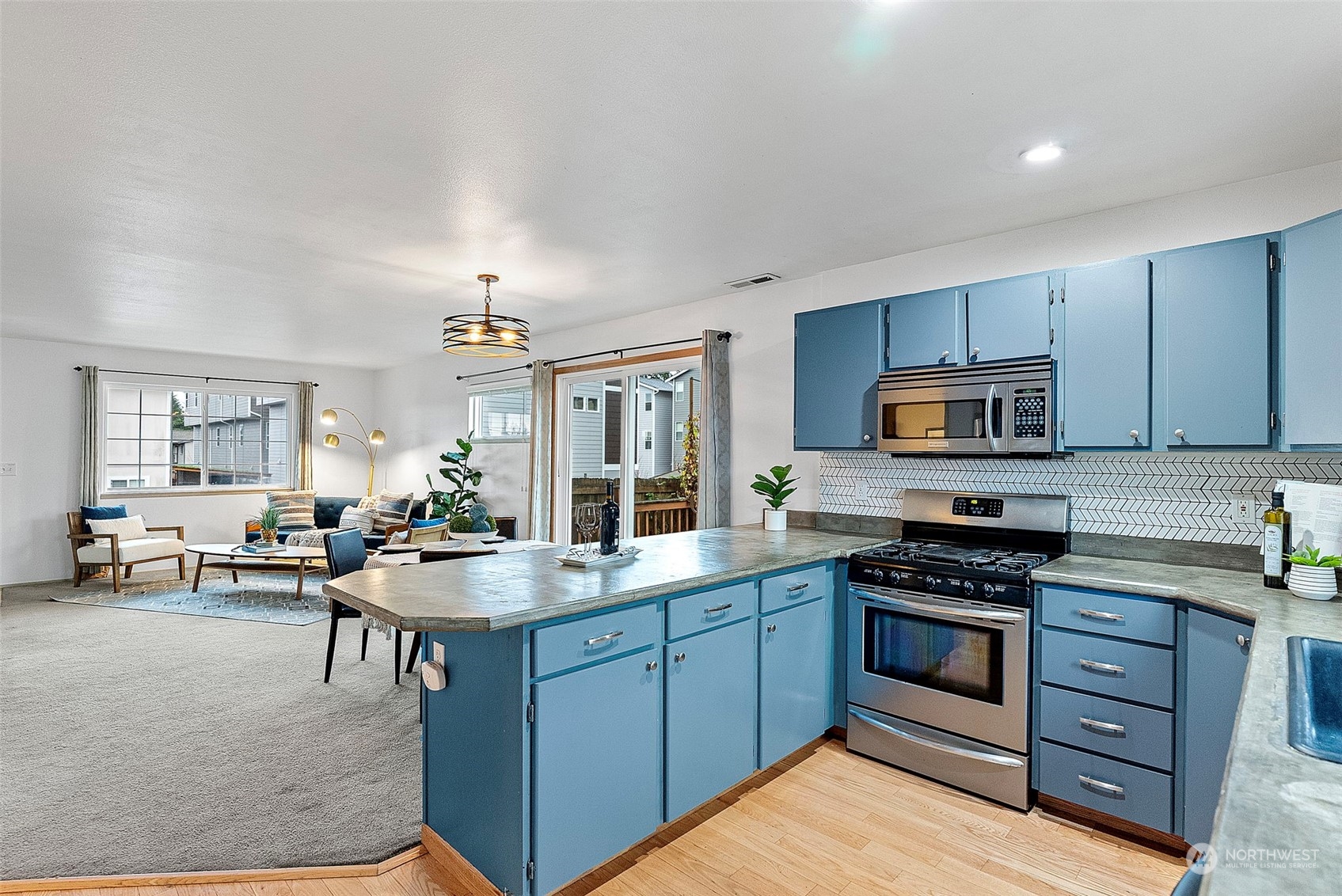 3962 Broadmoor Loop Bremerton, WA 98310 - Photo 5 of 22 a kitchen with sink cabinets and stove top oven