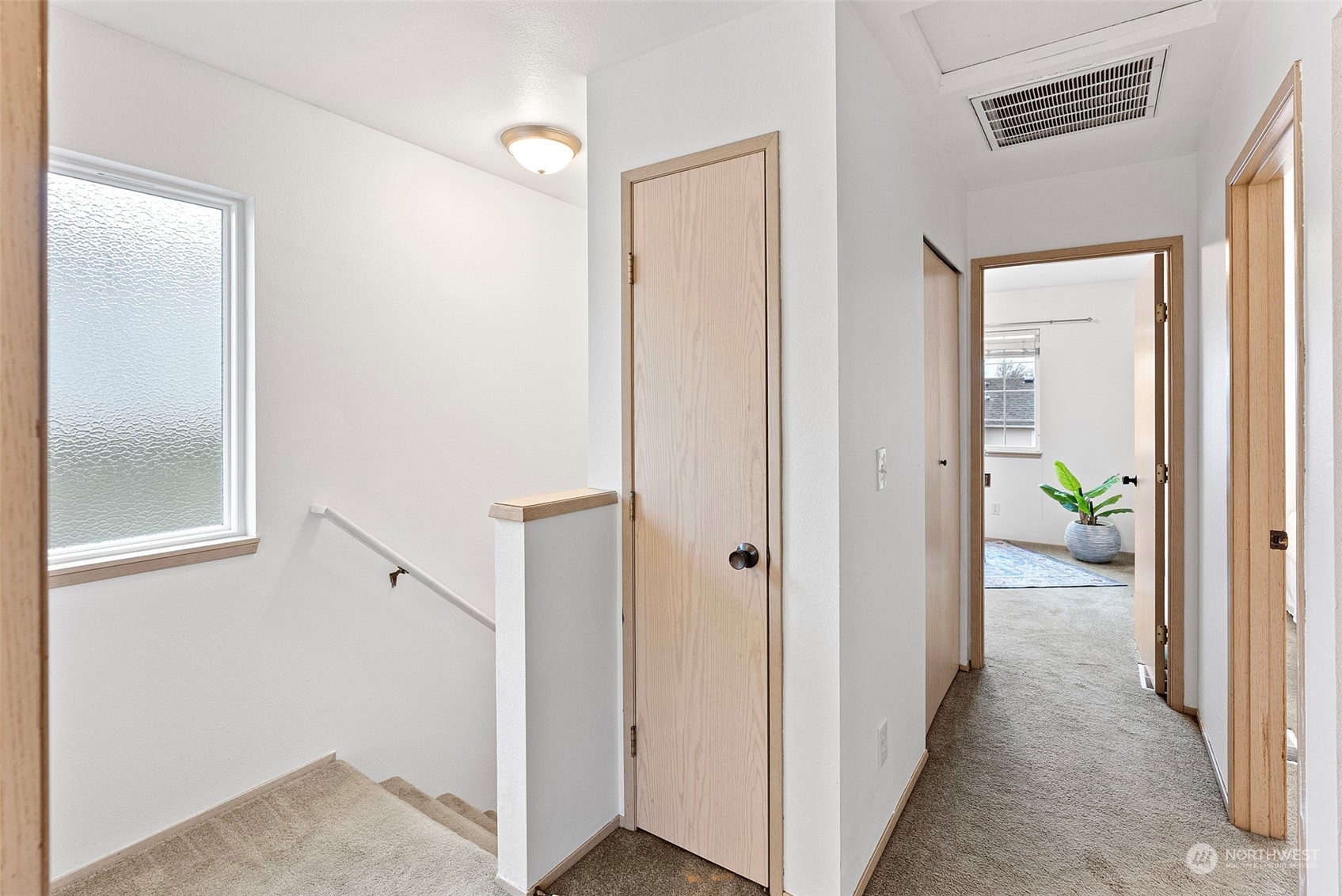3962 Broadmoor Loop Bremerton, WA 98310 - Photo 9 of 22 a view of a hallway with wooden floor and a bathroom