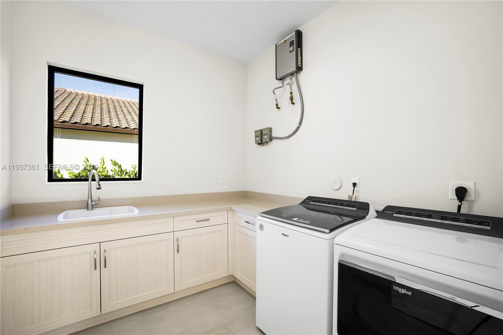 5197 Julienne Road Ave Maria, FL 34142 - Photo 19 of 43 Laundry room with cabinetry and utility space