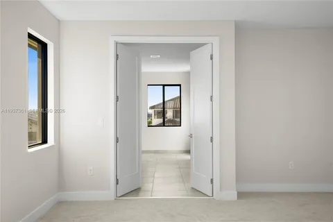 a view of a hallway with a glass door and a window