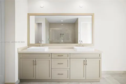 a bathroom with a sink vanity and mirror