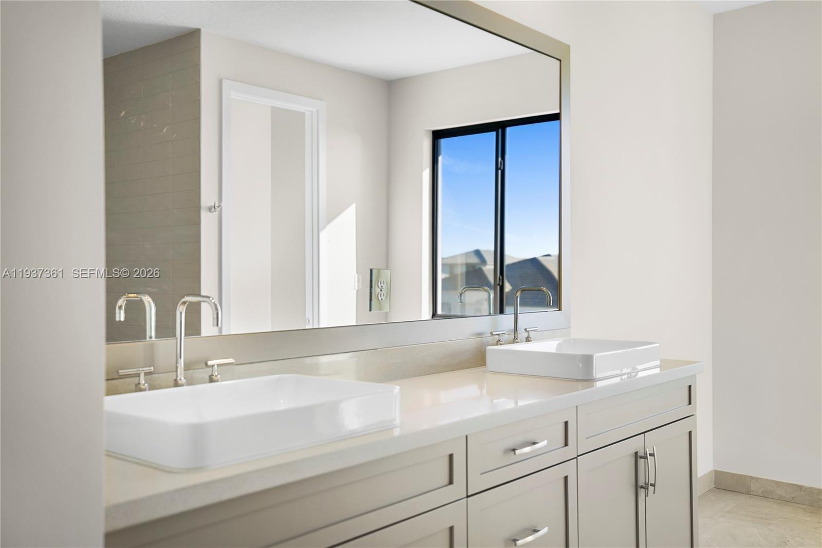 5197 Julienne Road Ave Maria, FL 34142 - Photo 30 of 44 a bathroom with a sink and a mirror