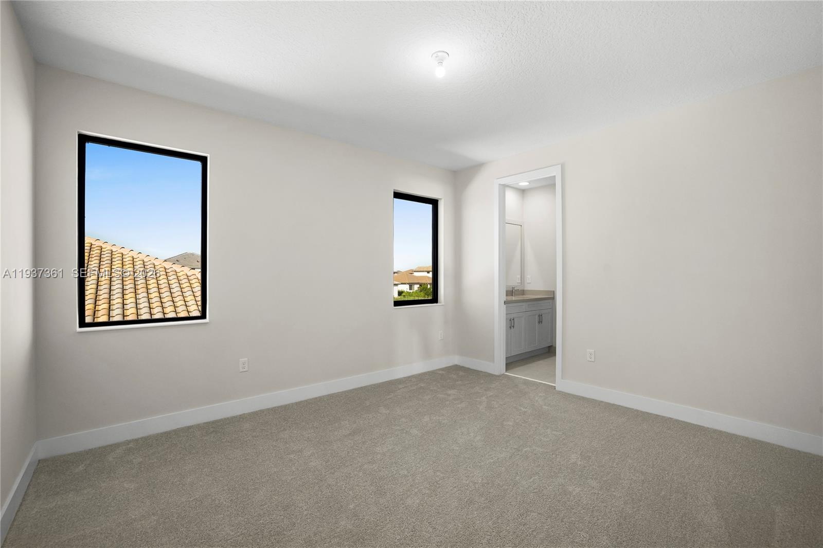 5197 Julienne Road Ave Maria, FL 34142 - Photo 36 of 44 an empty room with windows and closet