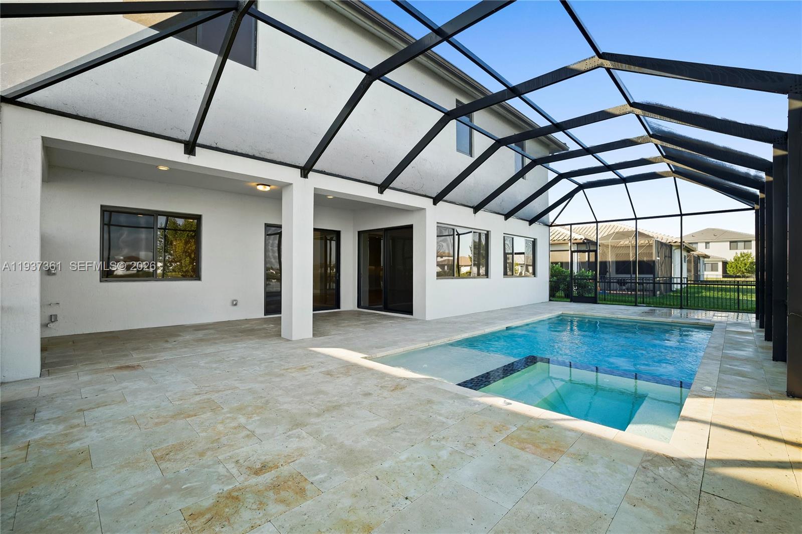 5197 Julienne Road Ave Maria, FL 34142 - Photo 5 of 43 Lakefront heated saltwater pool and spa with travertine decking