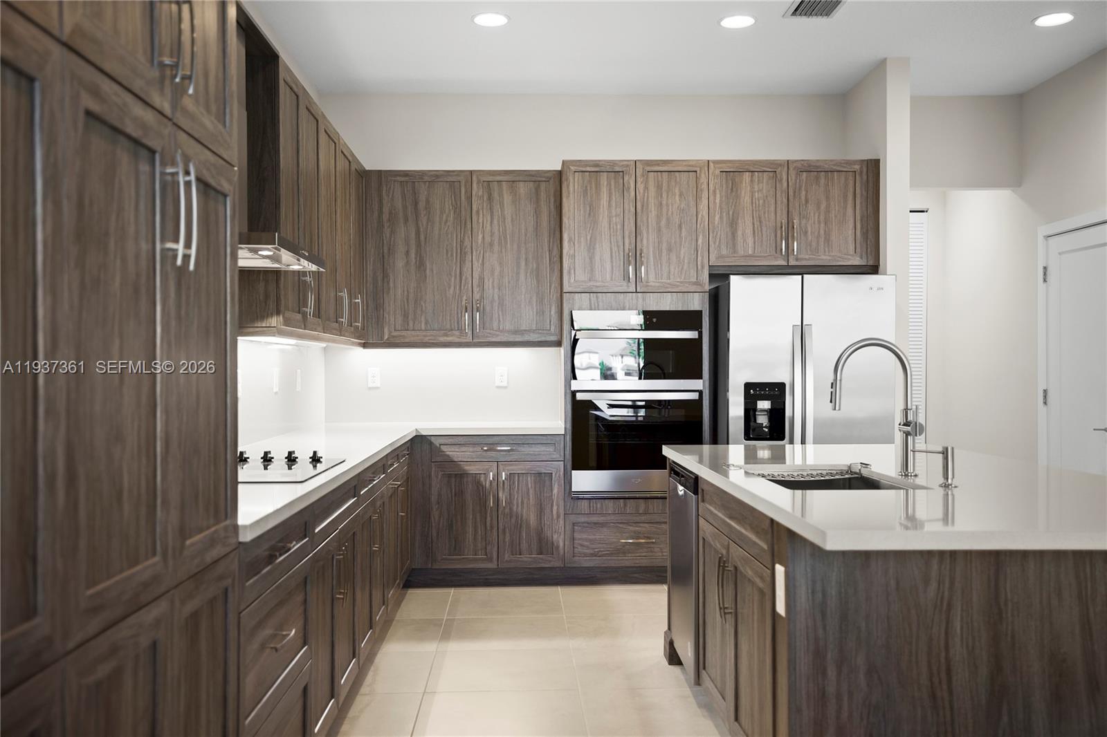 5197 Julienne Road Ave Maria, FL 34142 - Photo 9 of 43 Chef’s kitchen with stainless steel appliances and upgraded cabinetry