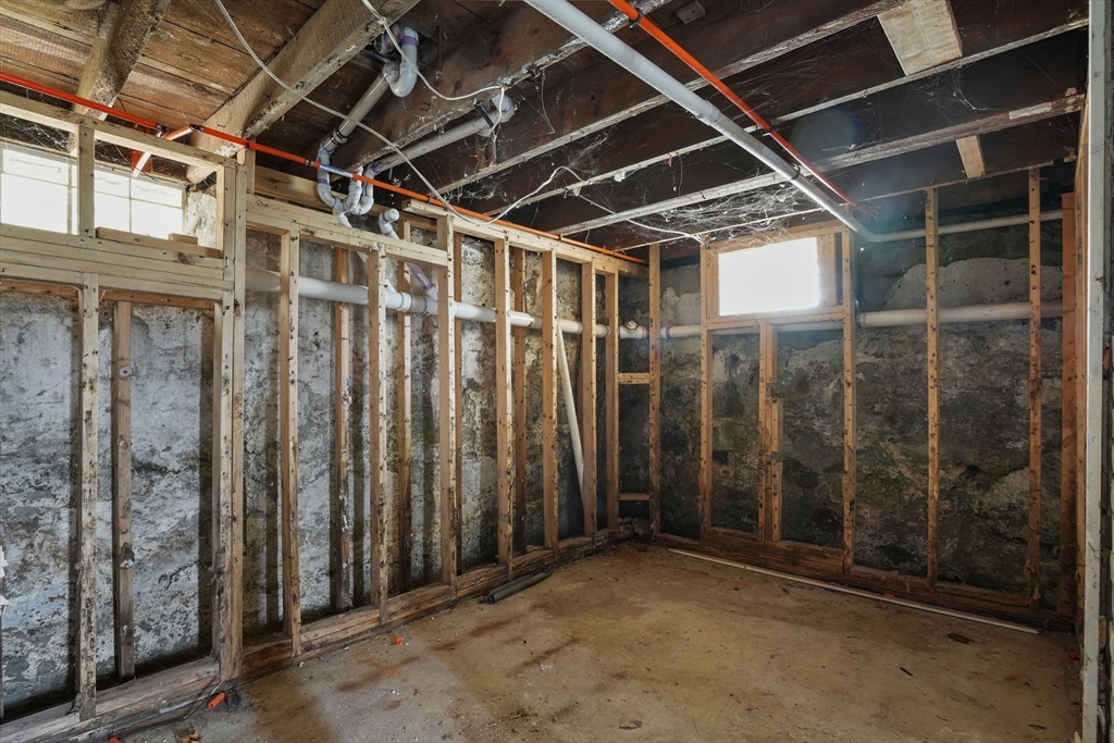 213 Weetamoe Street Fall River, MA 02720 - Photo 11 of 34 a view of an empty room with wooden walls