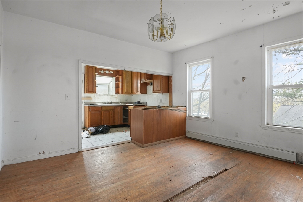 213 Weetamoe Street Fall River, MA 02720 - Photo 2 of 34 an empty room with a window and kitchen view