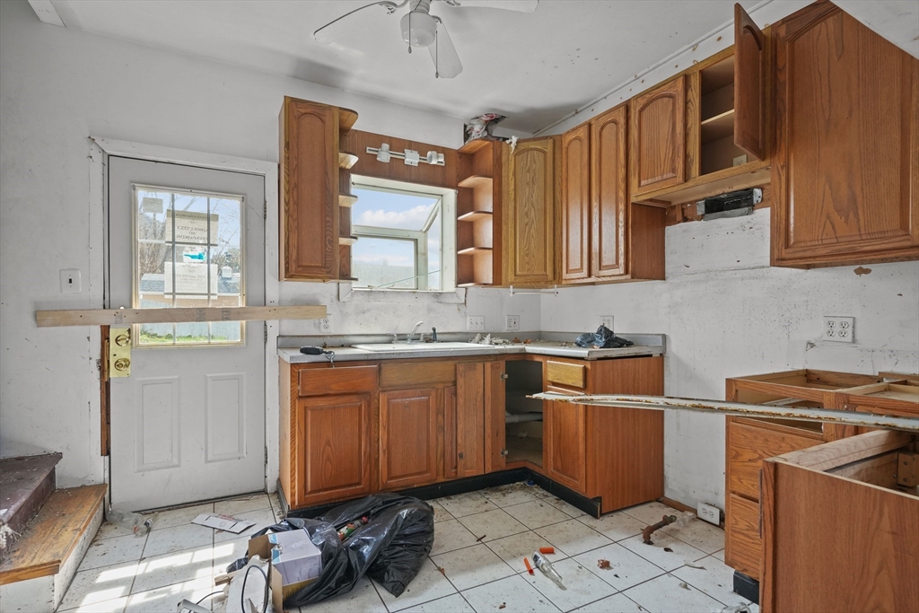 213 Weetamoe Street Fall River, MA 02720 - Photo 25 of 34 a kitchen with stainless steel appliances granite countertop a sink stove and cabinets