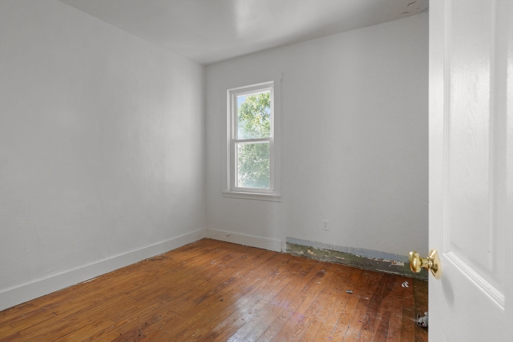 213 Weetamoe Street Fall River, MA 02720 - Photo 28 of 34 a view of a room with wooden floor and window