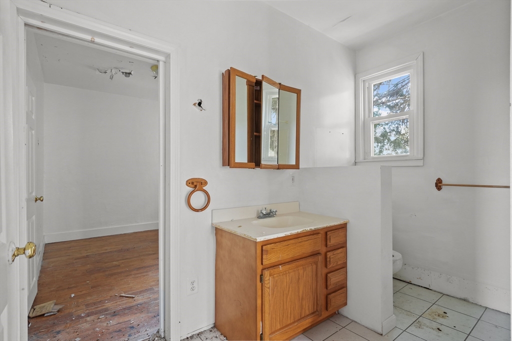 213 Weetamoe Street Fall River, MA 02720 - Photo 30 of 34 a utility room with a sink a toilet and a mirror