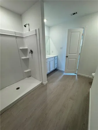 a bathroom with a glass door shower