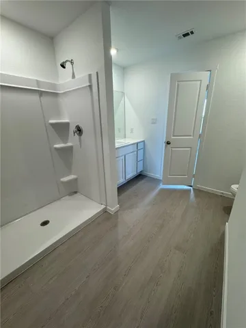 a bathroom with a glass door shower