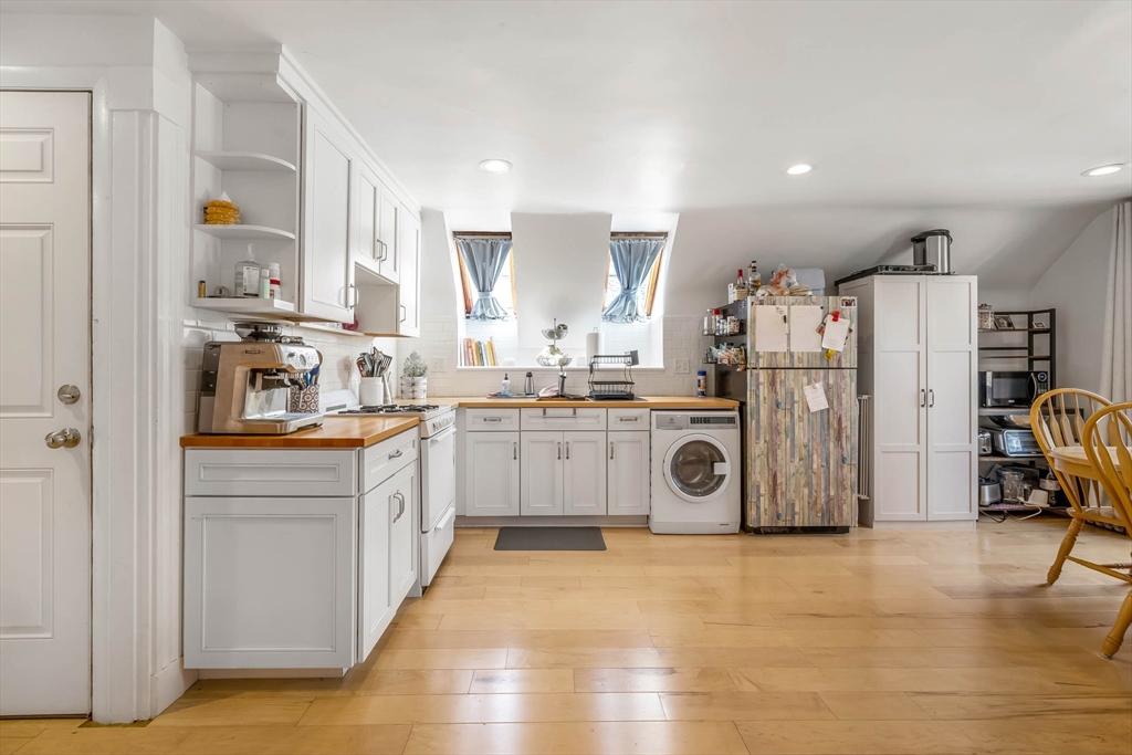 151 Magazine Street, Unit 3 Cambridge, MA 02139 - Photo 4 of 26 a kitchen with stainless steel appliances a refrigerator a sink and cabinets