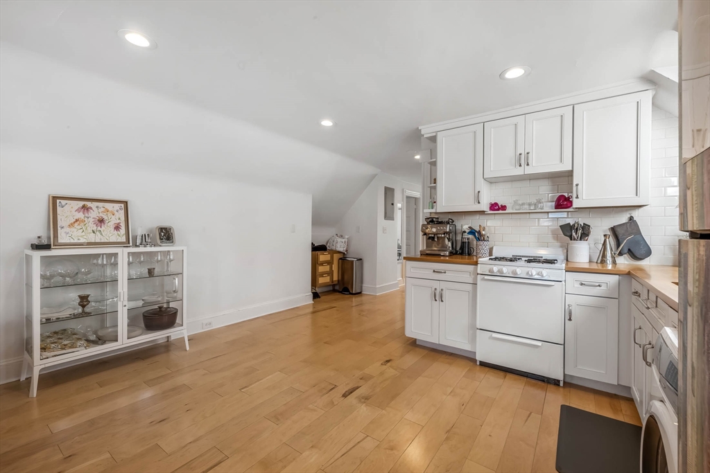 151 Magazine Street, Unit 3 Cambridge, MA 02139 - Photo 9 of 26 a kitchen with cabinets wooden floor and white appliances