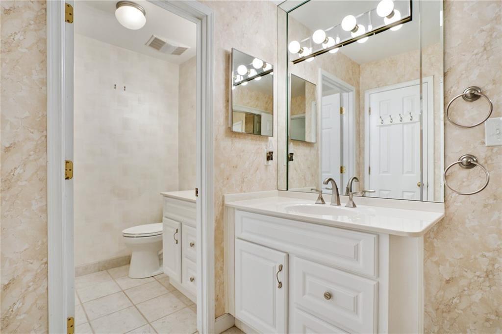 3203 Lenox Road Northeast, Unit 6 Atlanta, GA 30324 - Photo 16 of 27 a bathroom with a sink a toilet and a mirror