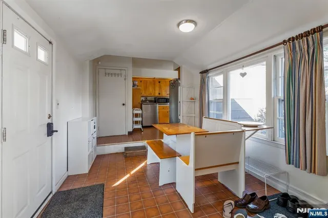 a dining room with furniture and large windows