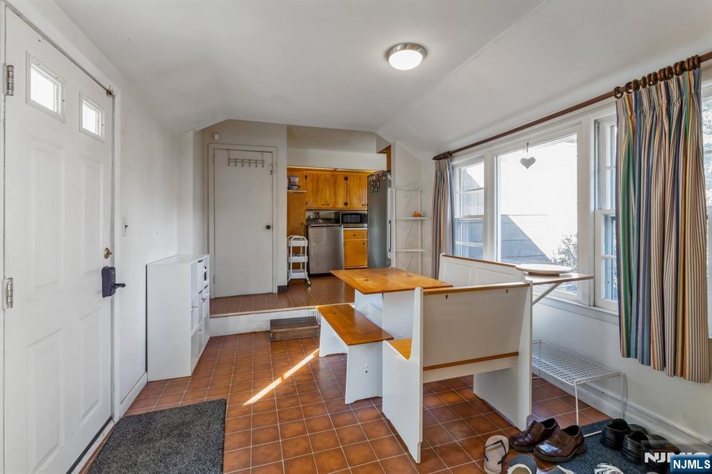 58 Taillon Terrace Closter, NJ 07624 - Photo 12 of 24 a dining room with furniture and large windows
