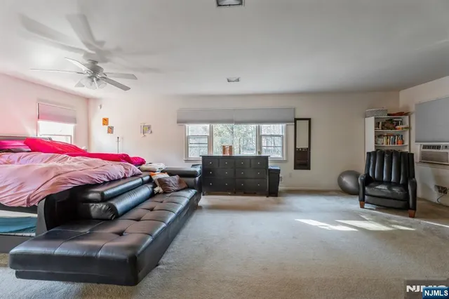 a bed room with a bed and a chair