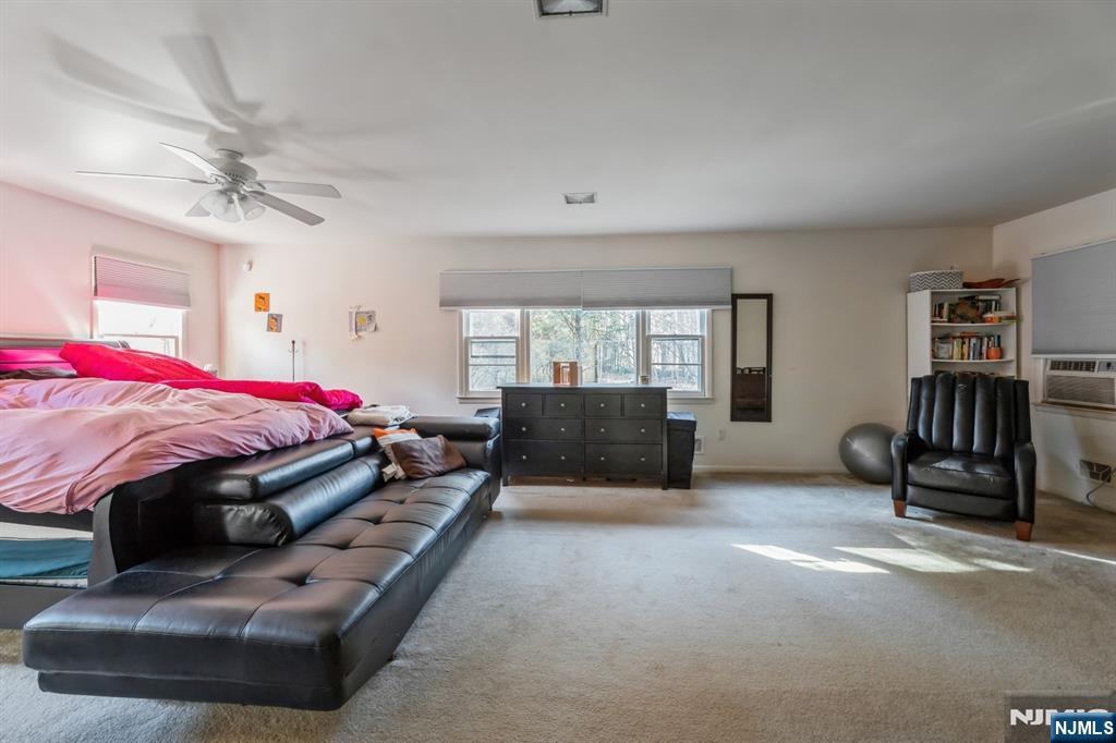 58 Taillon Terrace Closter, NJ 07624 - Photo 16 of 24 a bed room with a bed and a chair