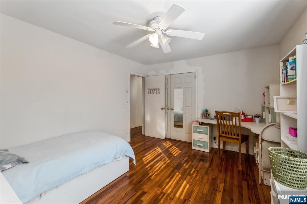 58 Taillon Terrace Closter, NJ 07624 - Photo 18 of 24 a bedroom with a bed and a chandelier