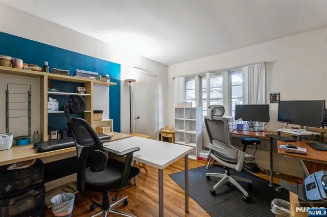 a view of a workspace with furniture and a window