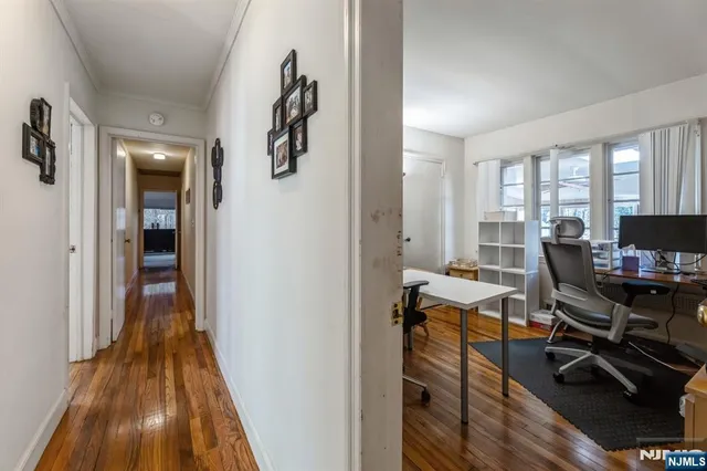 a view of a workspace with wooden floor and a window
