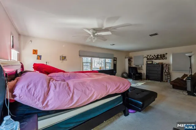 a bed room with a bed and a window