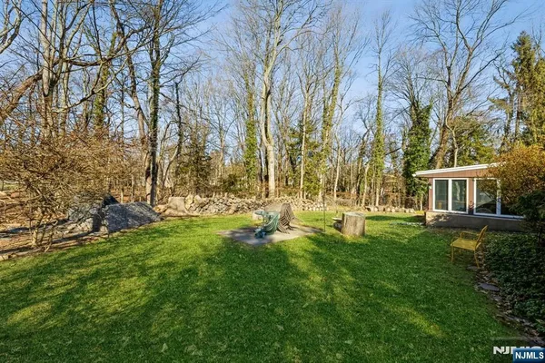 a view of backyard with house and trees