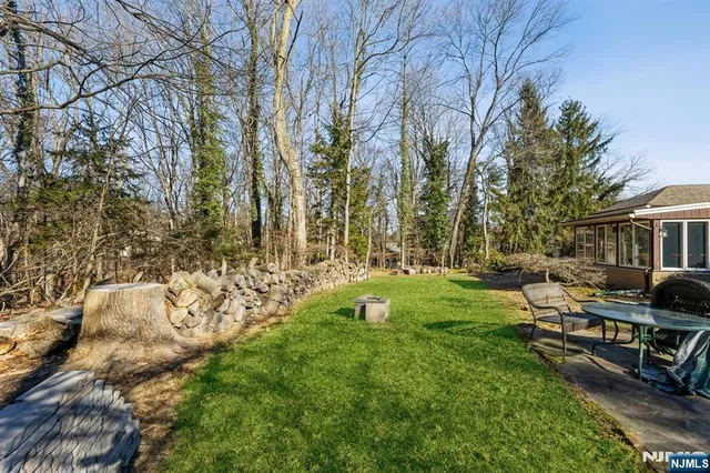 a view of backyard of house with outdoor seating and green space