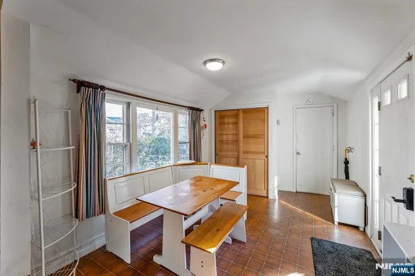 a living room with furniture a rug and a large window