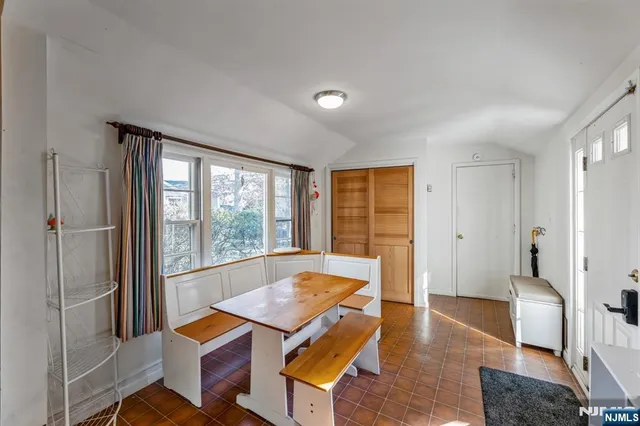 a living room with furniture a rug and a large window