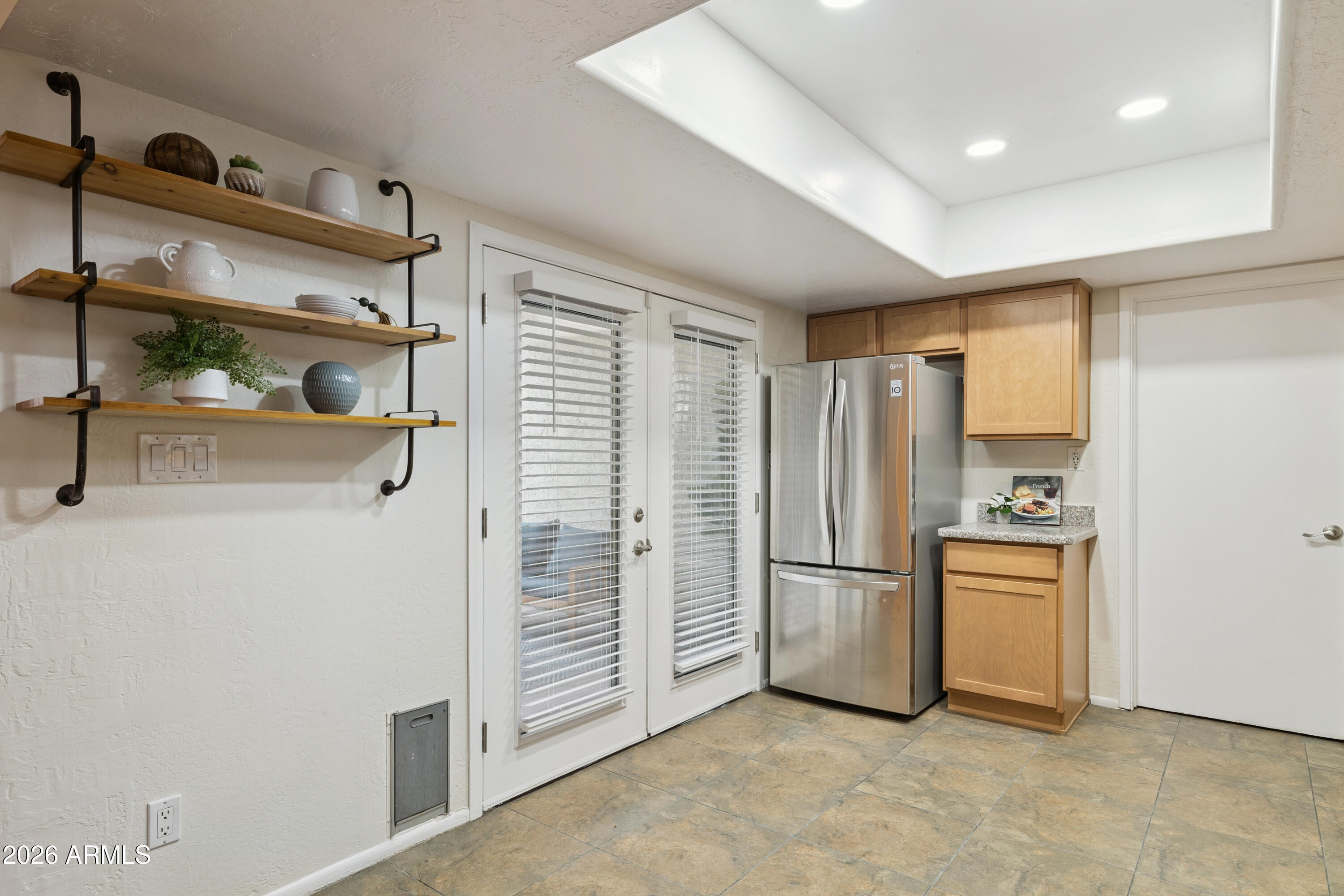 4343 East Osborn Road Phoenix, AZ 85018 - Photo 7 of 41 a view of a refrigerator in kitchen and an empty room