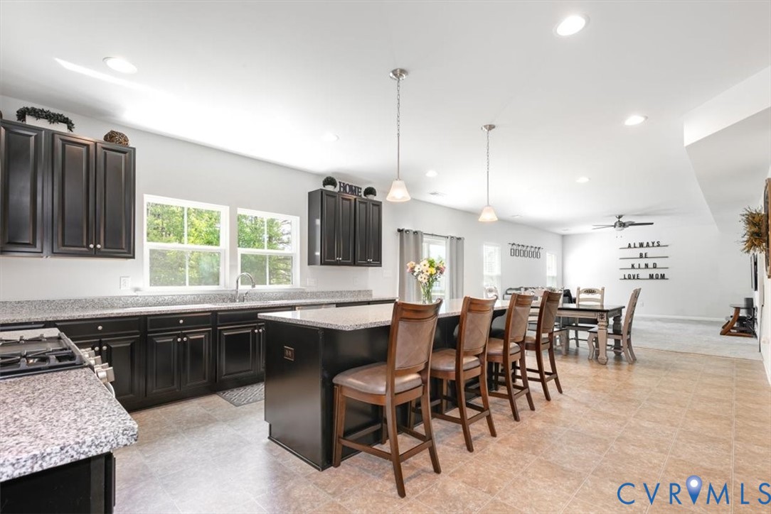 10430 Eagle Court Hopewell, VA 23860 - Photo 14 of 45 a kitchen with lots of counter space dining table and chairs