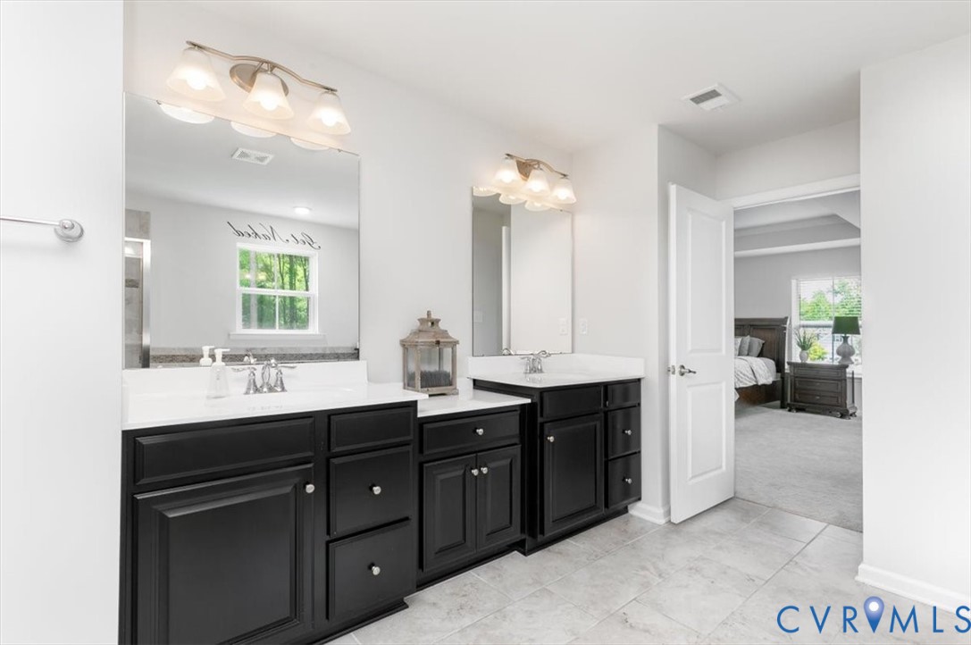 10430 Eagle Court Hopewell, VA 23860 - Photo 33 of 45 a spacious bathroom with a double vanity sink and a mirror