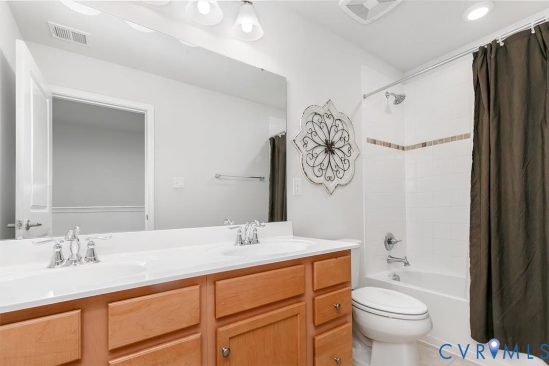 10430 Eagle Court Hopewell, VA 23860 - Photo 37 of 45 a bathroom with a granite countertop sink toilet and shower