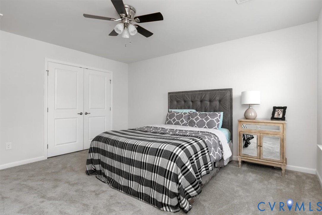 10430 Eagle Court Hopewell, VA 23860 - Photo 40 of 45 a bedroom with a bed and a chandelier