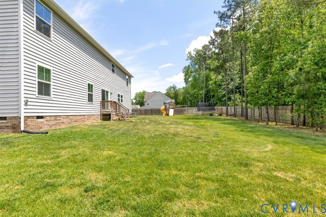 10430 Eagle Court Hopewell, VA 23860 - Photo 42 of 45 a backyard of a house with lots of green space