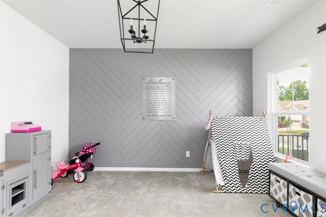 10430 Eagle Court Hopewell, VA 23860 - Photo 9 of 45 a bedroom with a bed and a chandelier