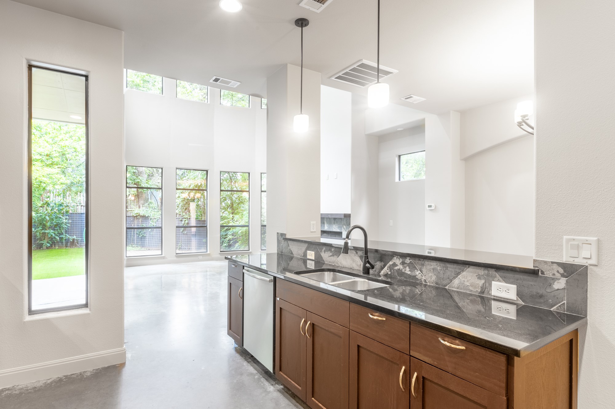 2310 Thornton Road, Unit A Austin, TX 78704 - Photo 13 of 32 a bathroom with a granite countertop sink and a large mirror