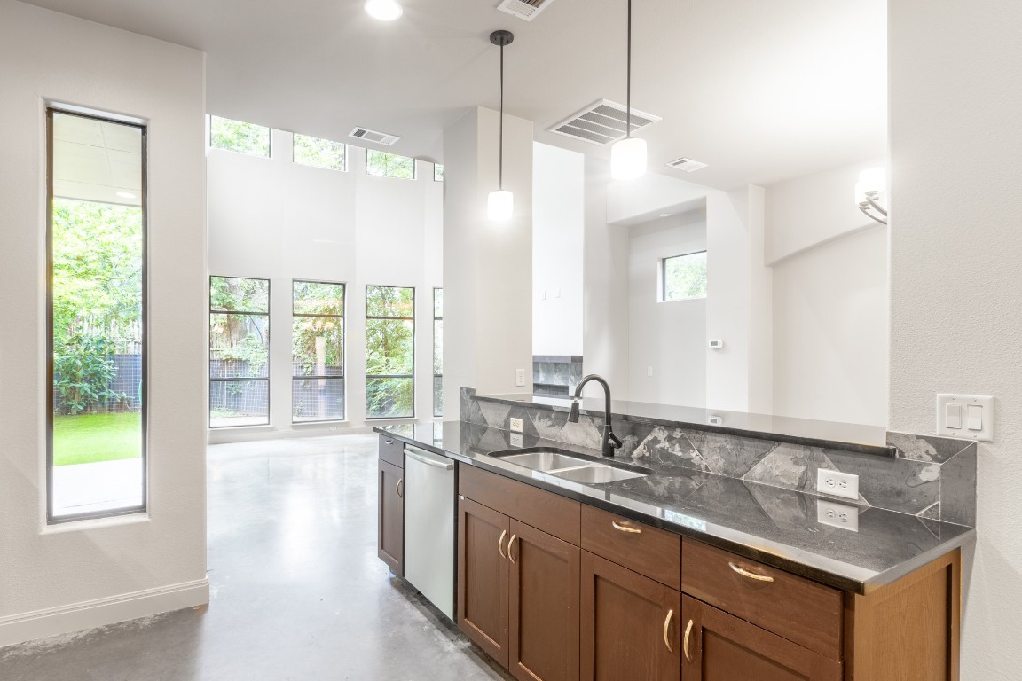 2310 Thornton Road, Unit A Austin, TX 78704 - Photo 13 of 32 a bathroom with a granite countertop sink and a large mirror
