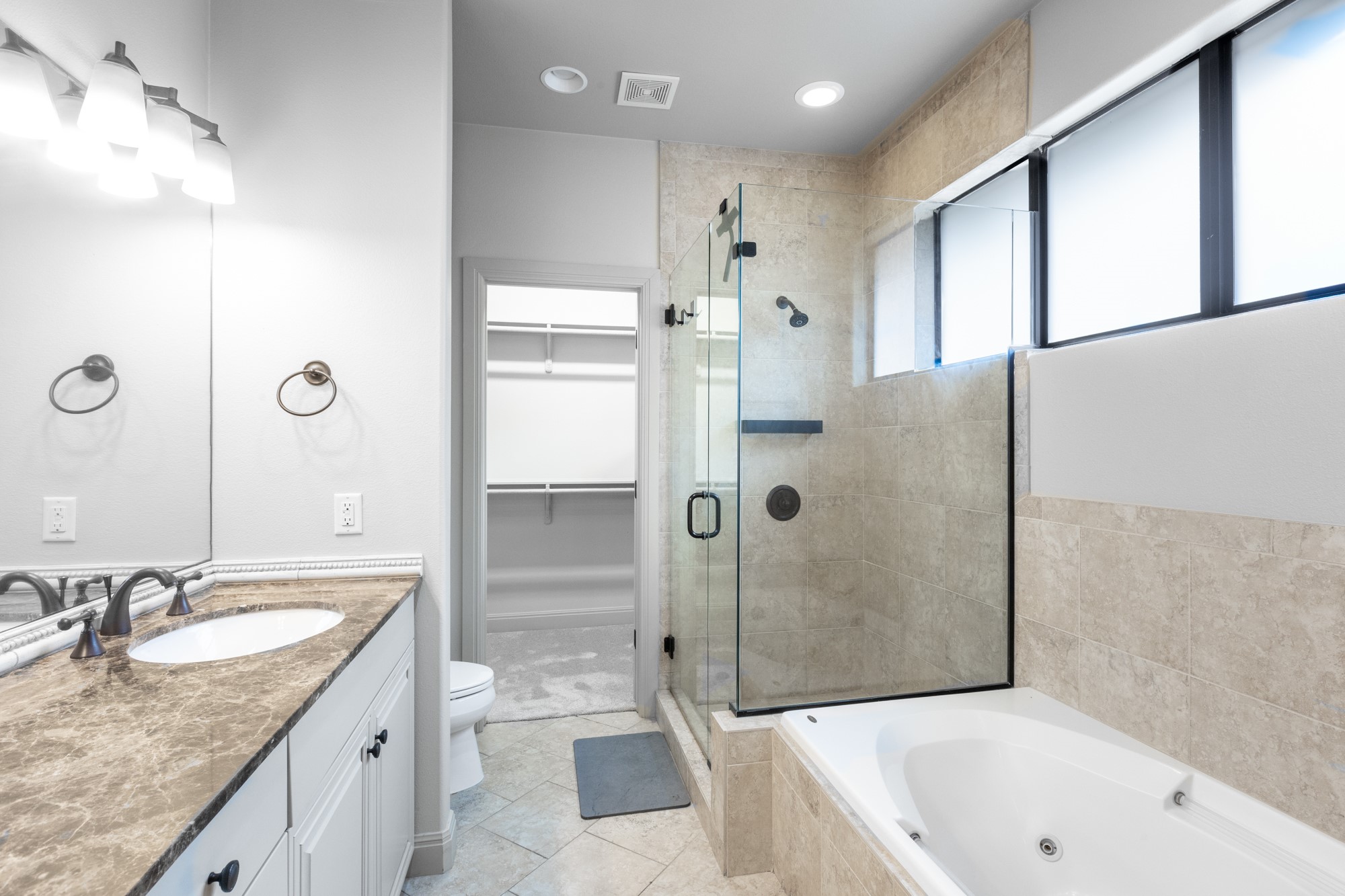 2310 Thornton Road, Unit A Austin, TX 78704 - Photo 20 of 32 a bathroom with a granite countertop sink mirror bathtub and shower