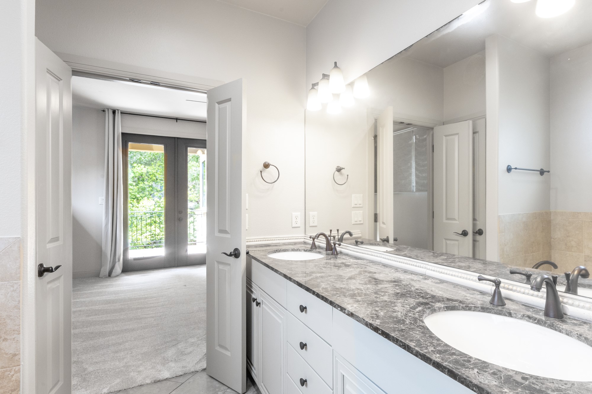2310 Thornton Road, Unit A Austin, TX 78704 - Photo 22 of 32 a bathroom with a granite countertop sink and a mirror