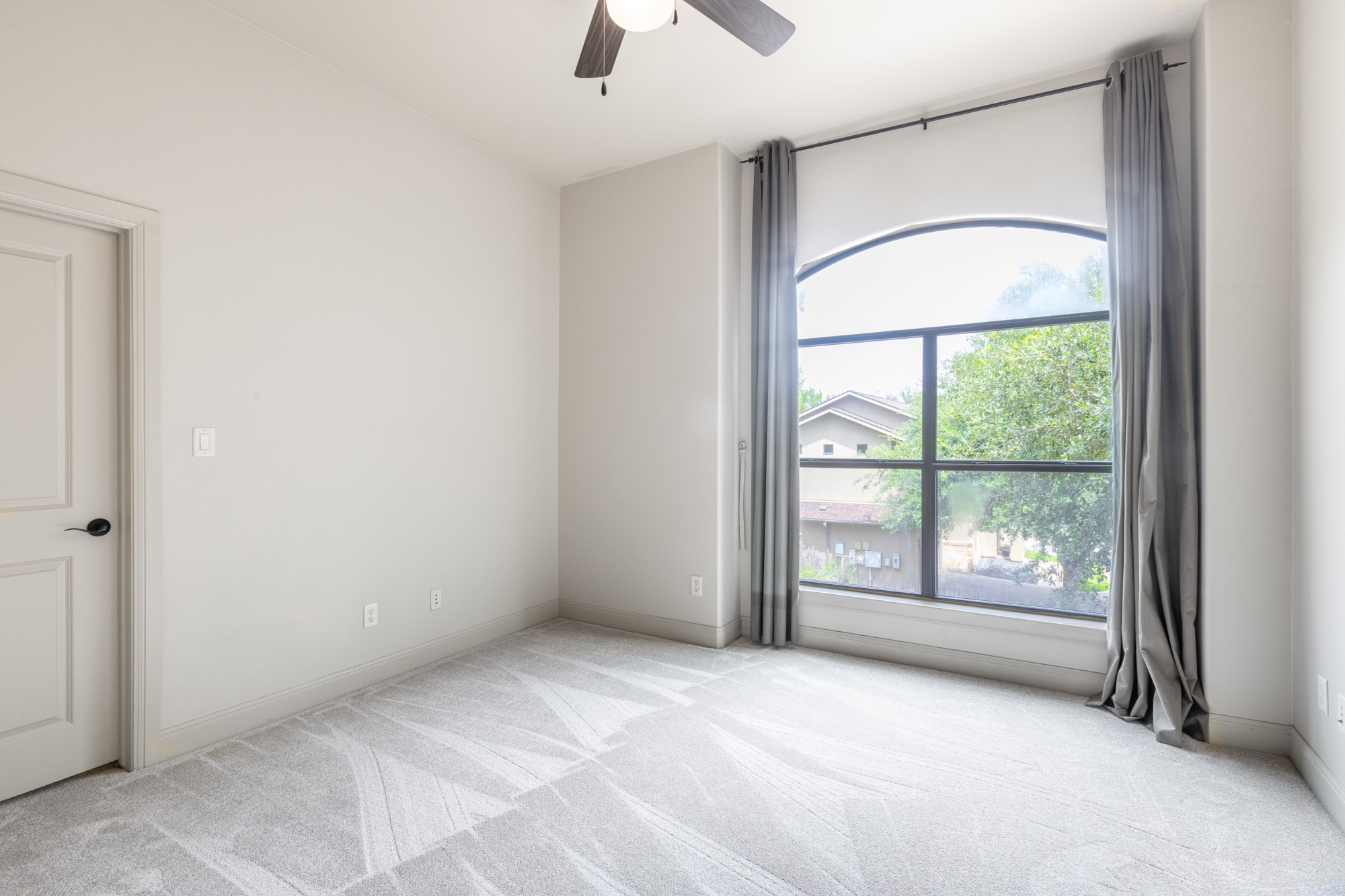 2310 Thornton Road, Unit A Austin, TX 78704 - Photo 23 of 32 an empty room with windows and ceiling fan