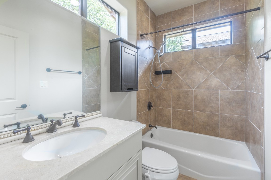 2310 Thornton Road, Unit A Austin, TX 78704 - Photo 25 of 32 a bathroom with a sink toilet and shower