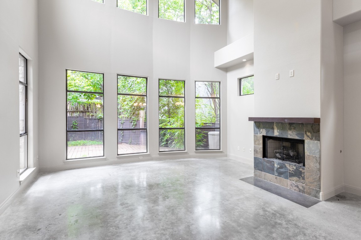 2310 Thornton Road, Unit A Austin, TX 78704 - Photo 10 of 32 a view of an empty room with a fireplace and a window